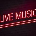 Red neon sign with live music text on wall glow