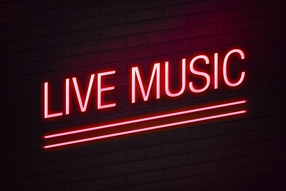 Red neon sign with live music text on wall glow