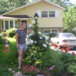 Ruth Z. "The Belle of Cowbell Road" Deming, MGPGP, Director/ Gardener/ Artist. "Channel your feelings into Art!" Note Orange Hazard Cone studded with American Flags, Red Poppies on Right. 5-30-07