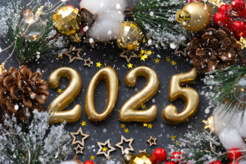 The golden figures 2025 made of candles on a black stone slate b