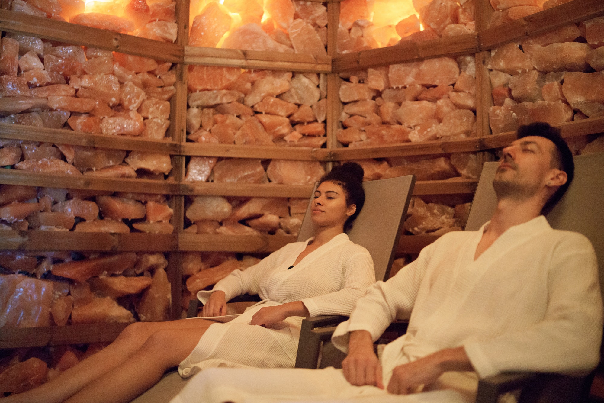 Portrait of young couple in salt inhalation steam room, relaxing